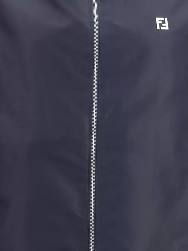 Navy blue jacket with a zipper and Fendi logo on a dark background