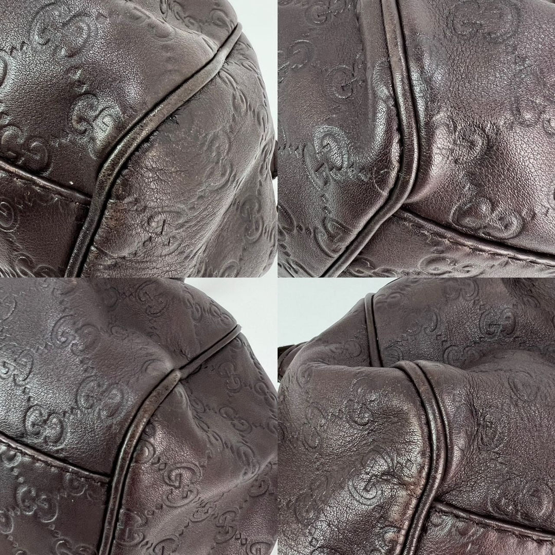 Close-up of a brown textured leather bag with intricate patterns.