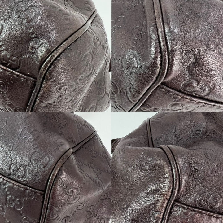 Close-up of a brown textured leather bag with intricate patterns.