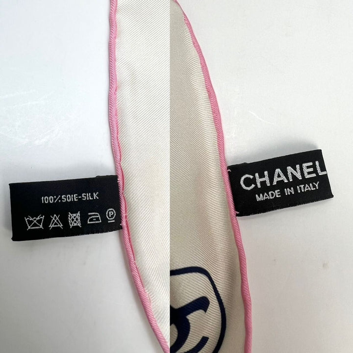 Close-up of a Chanel silk scarf with labels indicating fabric type and origin.