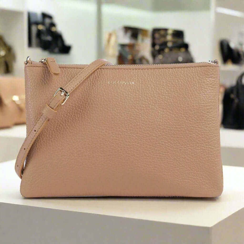 Beige handbag with a strap on a white background