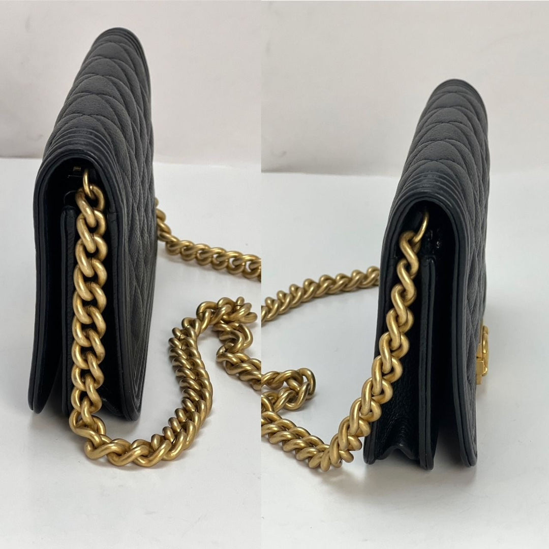 Chanel Caviar Quilted Mini Boy Clutch Wallet on a Chain Black side view showcasing antique gold chain hardware.