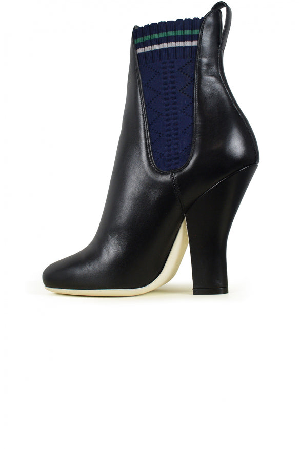 Black ankle boot with a high heel on a white background