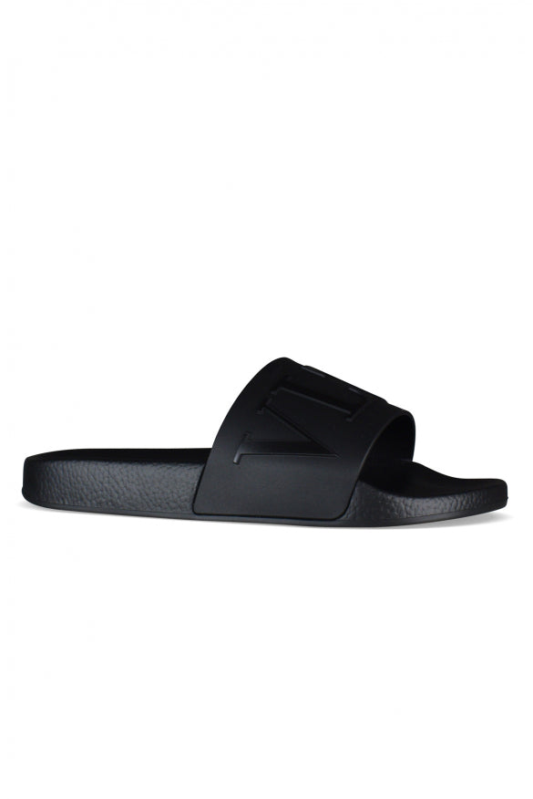 Black slide sandal on a white background