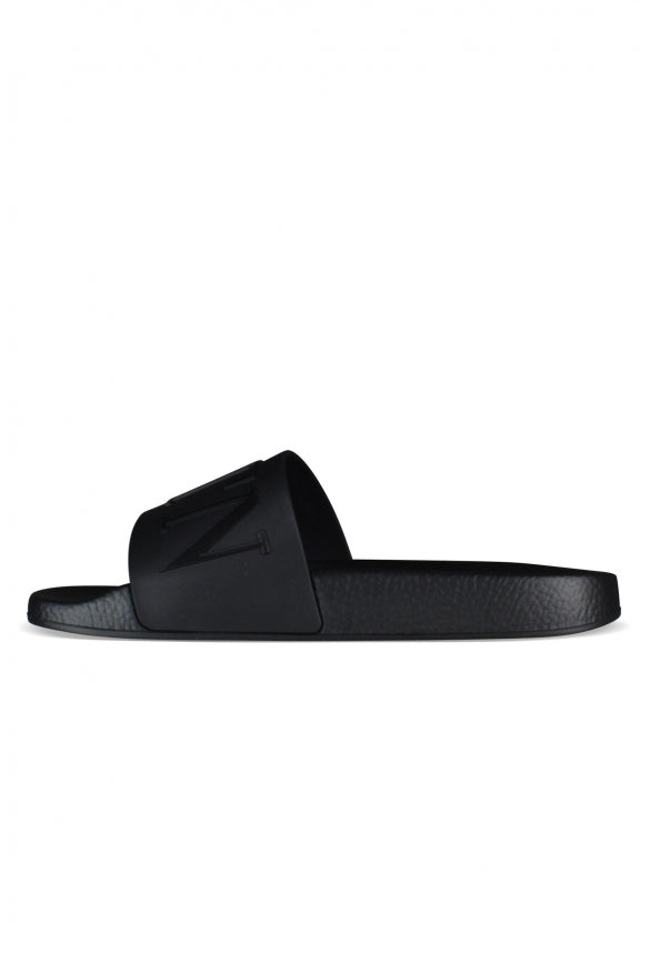 Black slide sandal on a white background