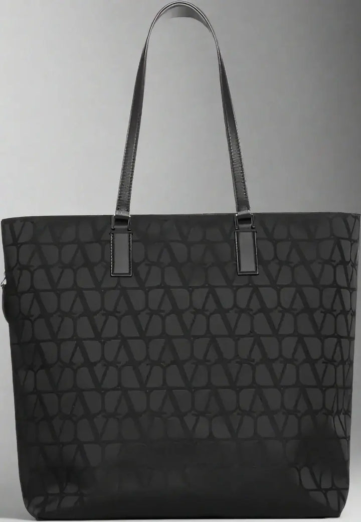 Black quilted tote bag on a white background