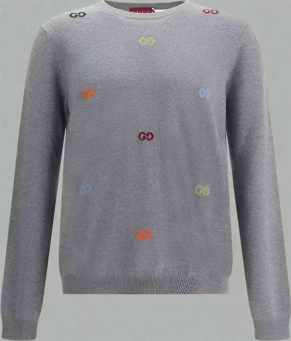 Gray sweater with colorful embroidered symbols on a white background