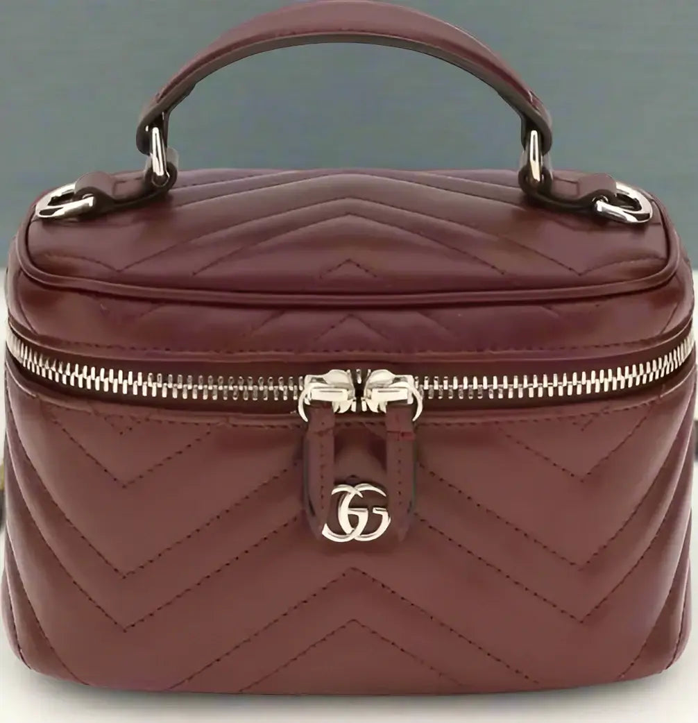 Quilted brown handbag with a silver logo on a white background
