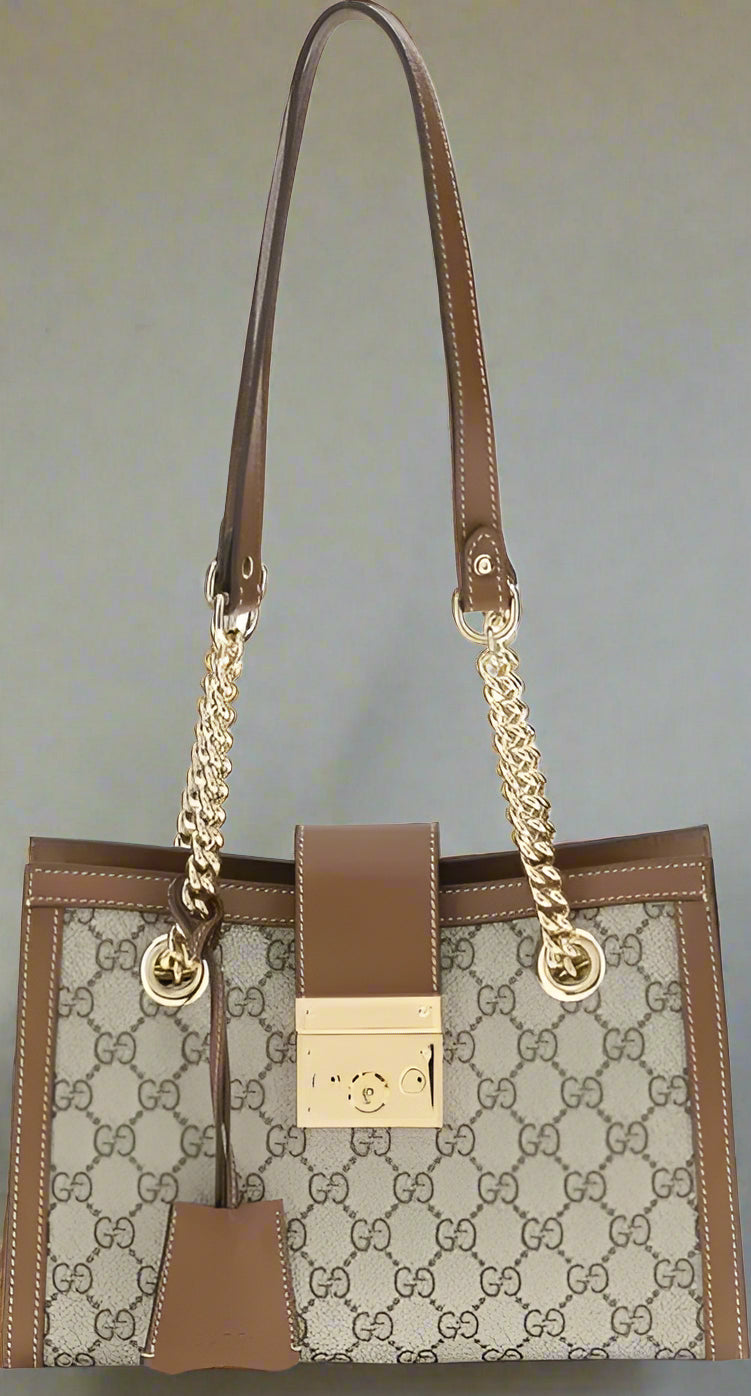 Designer handbag with brown and beige pattern on a white background