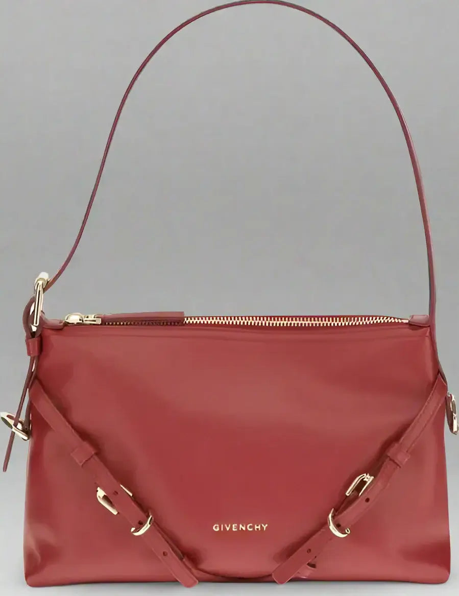 Red Givenchy handbag with gold accents on a white background