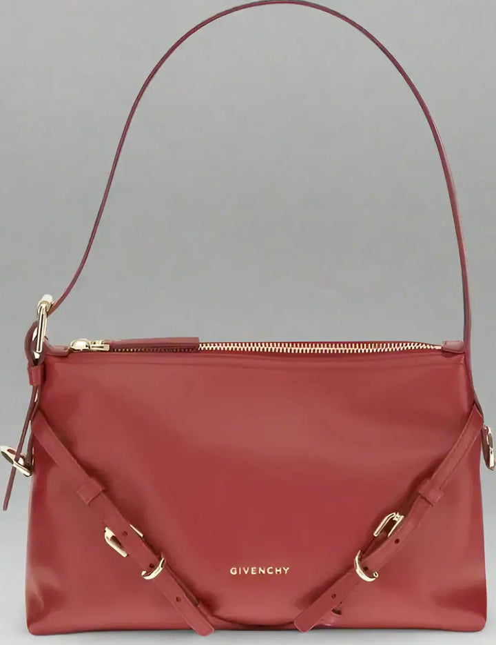 Red Givenchy handbag with gold accents on a white background