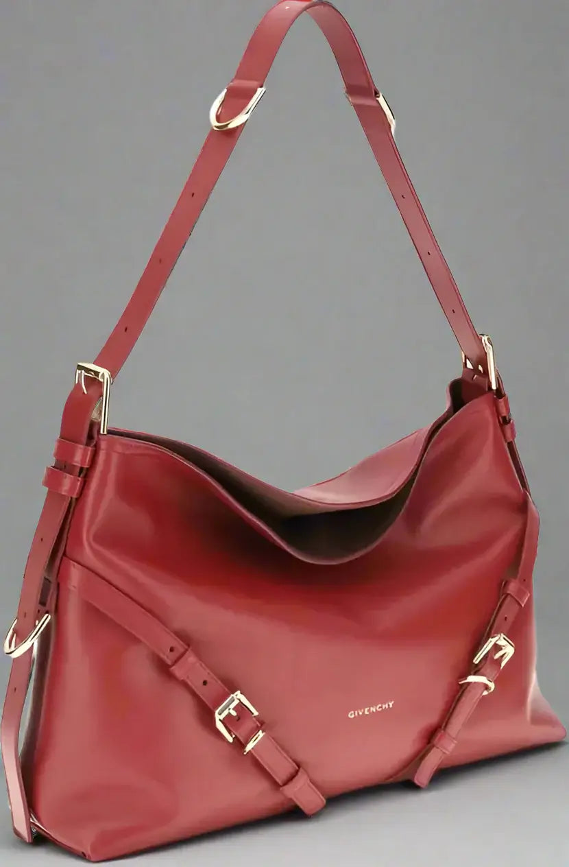 Red handbag with gold accents on a white background
