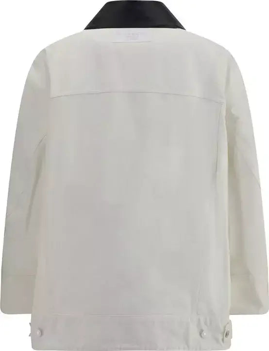 White denim jacket with black collar on a white background