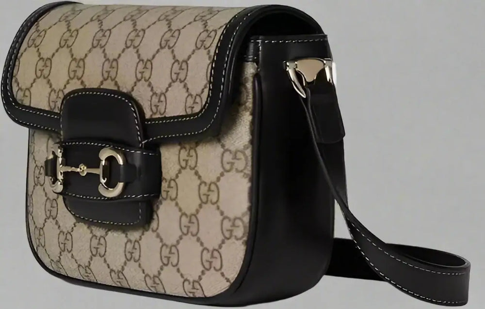Beige handbag with black accents on a white background