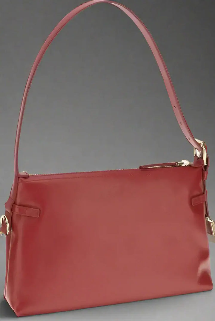 Red handbag with a strap on a white background