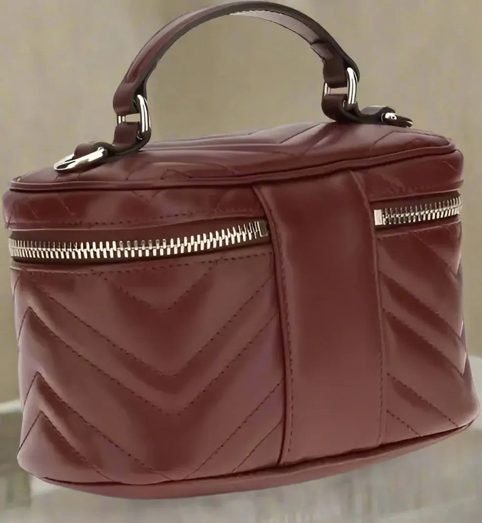 Maroon handbag with a chevron pattern on a white background