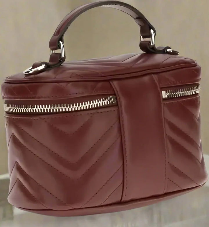 Maroon handbag with a chevron pattern on a white background