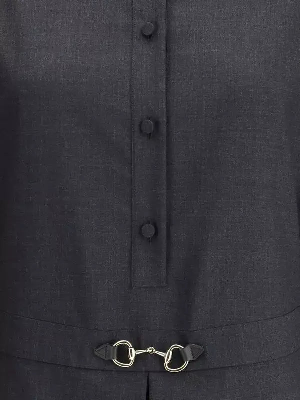 Dark gray coat with button details and a gold equestrian bit design on the placket.