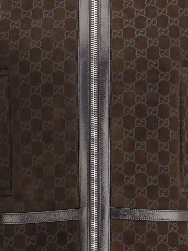 Brown suitcase with Gucci logo pattern and zipper