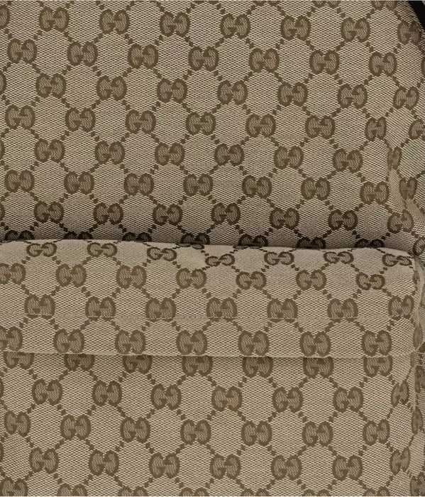 Close-up of a patterned fabric with a distinctive logo design.