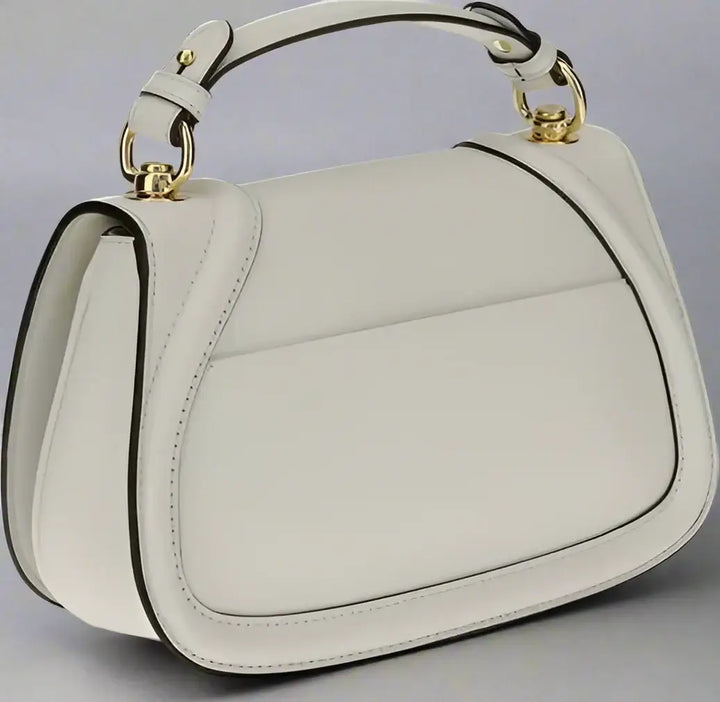 White handbag with gold accents on a white background