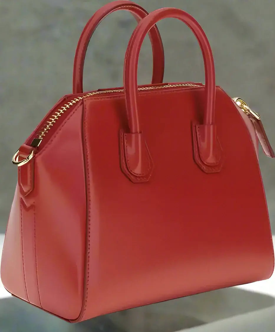 Red handbag with gold zipper on a white background