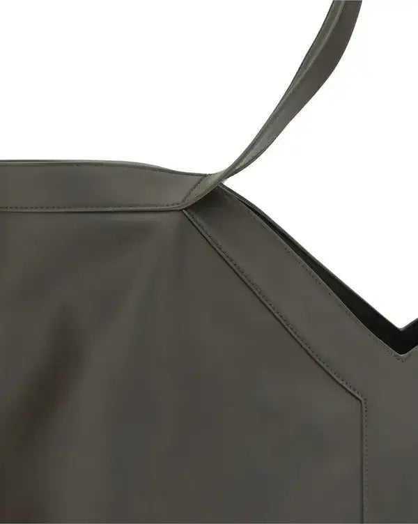 Close-up of a dark gray leather bag with a strap on a white background