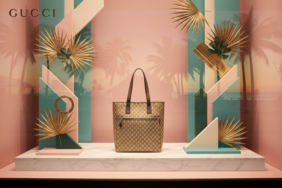Beige patterned tote bag with brown handles on a light gray background