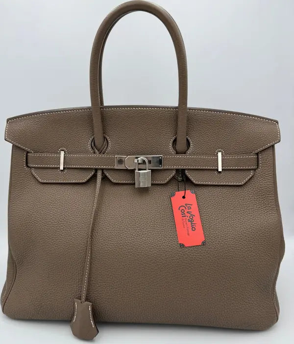 Brown handbag with a red tag on a white background