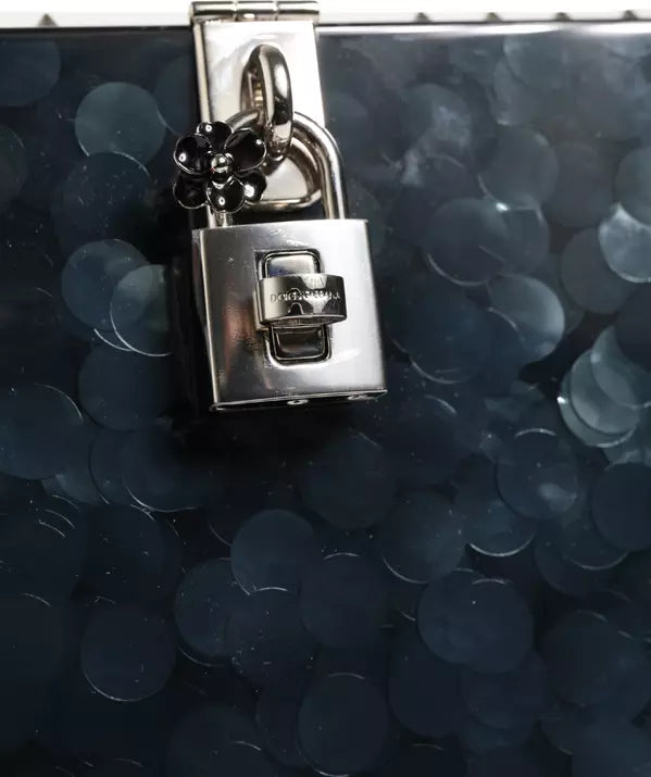 Close-up of a silver padlock on a dark blue textured surface