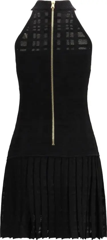 Black dress with a gold zipper on a white background