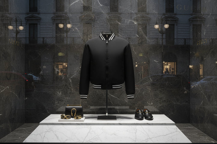 Black bomber jacket with white trim on a white background