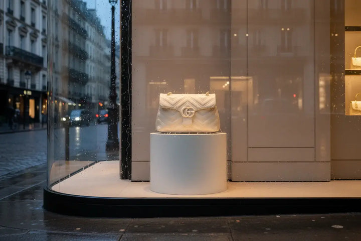 Beige quilted handbag with a brand logo on a white background
