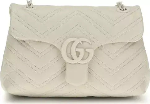 Beige quilted handbag with a brand logo on a white background