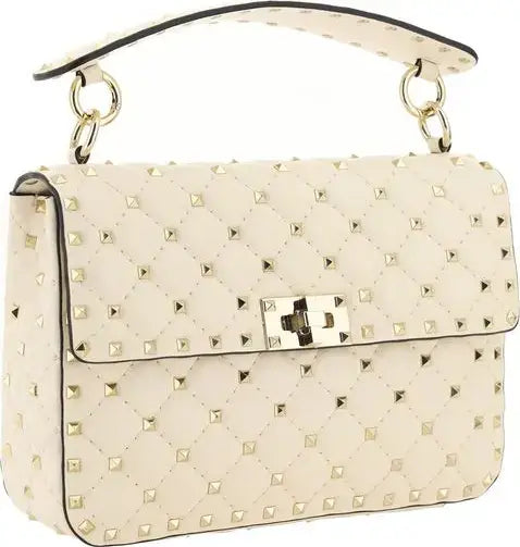 White handbag with gold studs and a gold clasp on a white background