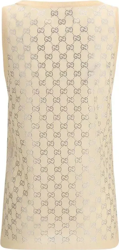 Beige sleeveless top with a pattern of small bows on a beige background