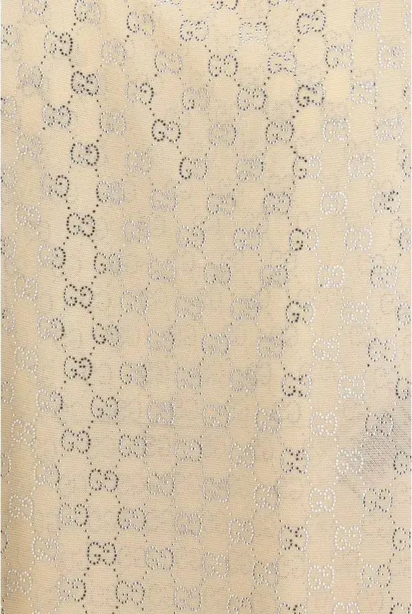 Patterned fabric with a repeating design on a beige background