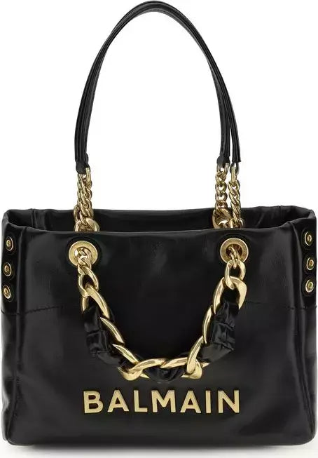Black handbag with gold chain details and Balmain logo on a white background
