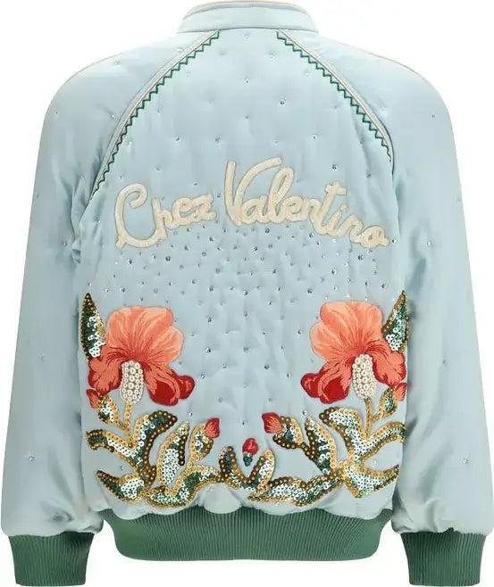 Light blue bomber jacket with floral embroidery and 'Chez Valentina' text on a white background