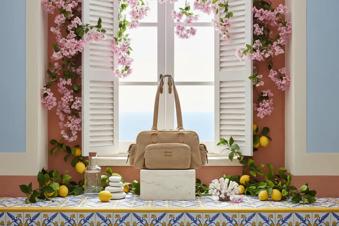Beige handbag with visible brand logo on a white background