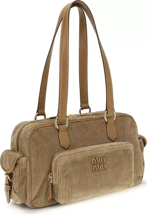 Brown corduroy handbag with visible brand logo on a white background