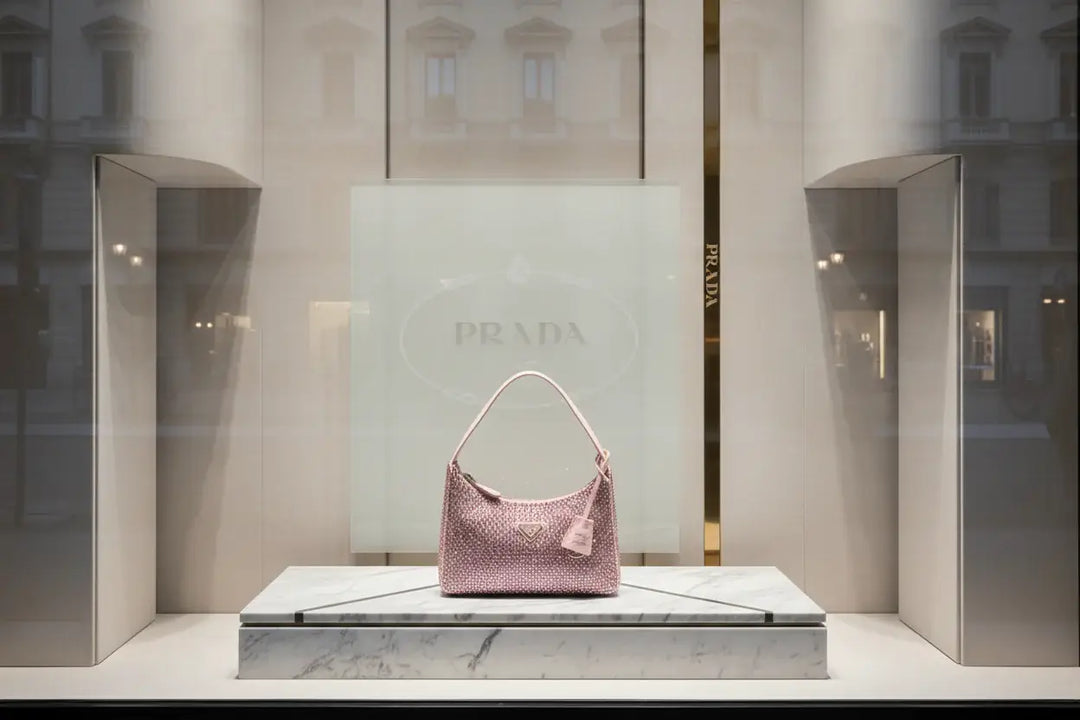 Pink handbag with rhinestone embellishments on a white background