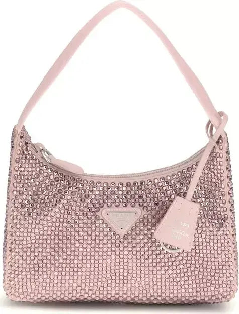 Pink handbag with rhinestone embellishments on a white background