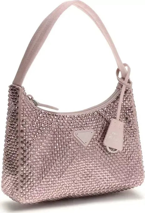 Pink handbag with studded details on a white background