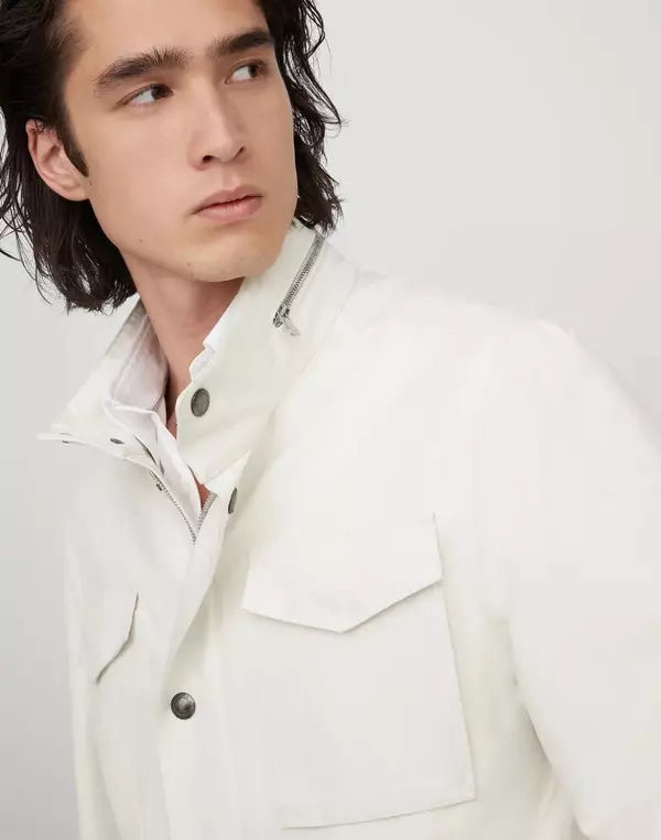 Man wearing a white jacket against a plain background
