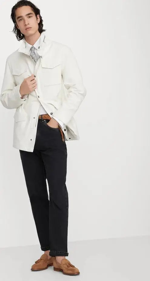Person wearing a white jacket and black pants on a white background