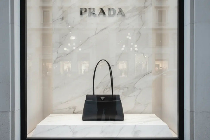 Black handbag with Prada logo on a white background