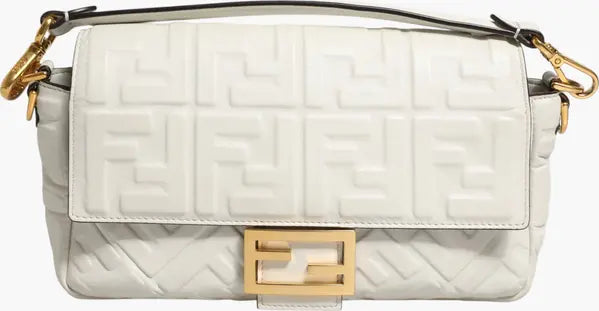 White quilted handbag with gold accents on a white background