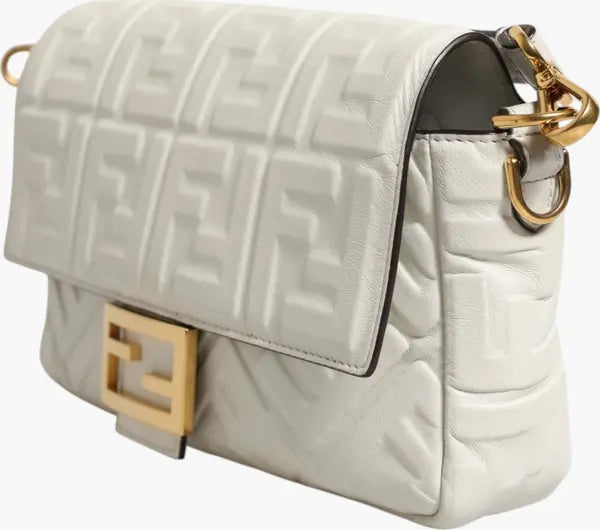 White quilted handbag with gold accents on a white background