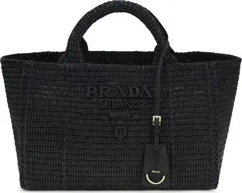 Black woven Prada handbag on a white background